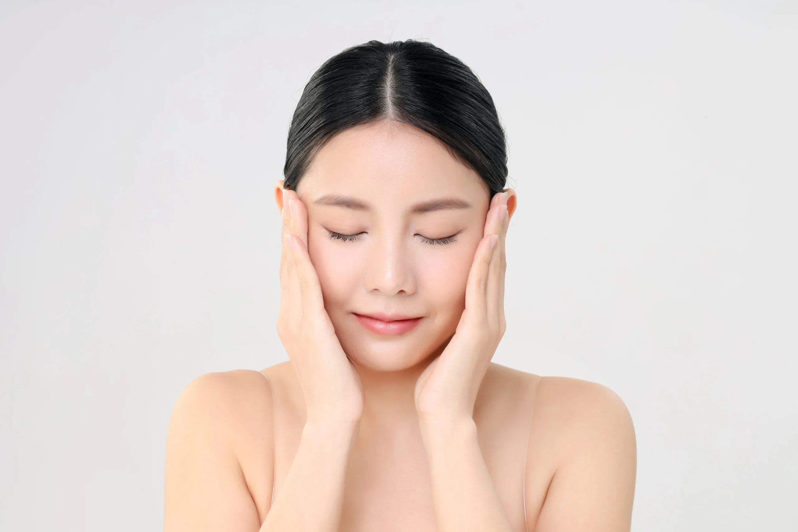 beautiful face young adult asian woman with clean fresh skin isolated white scaled